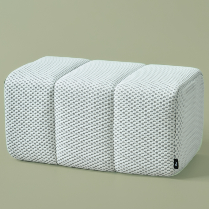 White Ottoman with a textured surface on a beige background