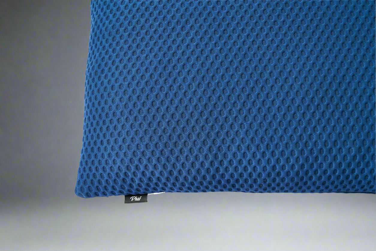 Blue textured pillow with a brand label "PHAF" on a gray background