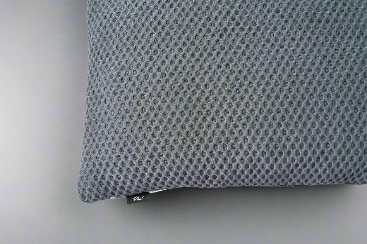 Gray  textured pillow with a brand label "PHAF" on a gray background