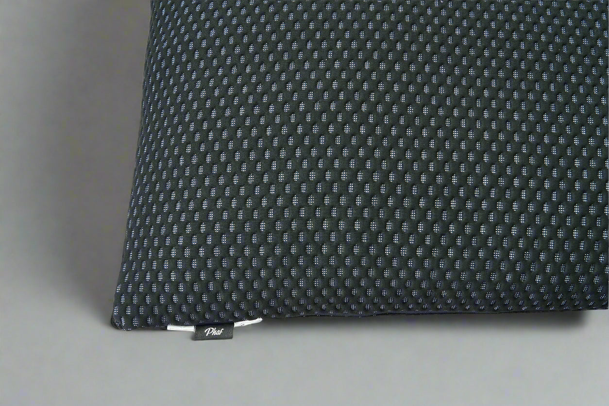 Black textured pillow with a brand label "PHAF" on a gray background