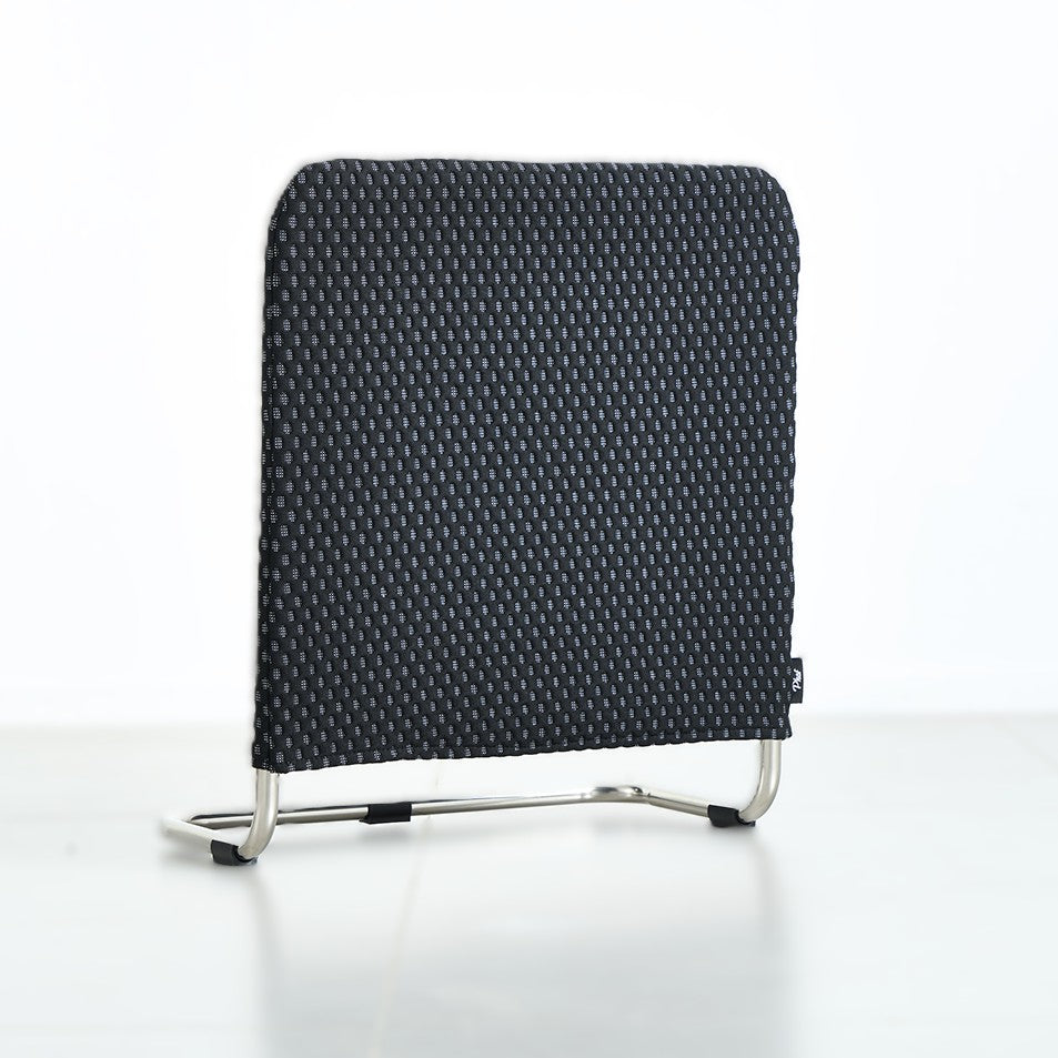 Black supporting bar with a patterned backrest on a gray background