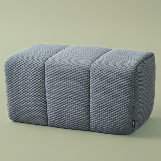 Gray textured ottoman on a light green background
