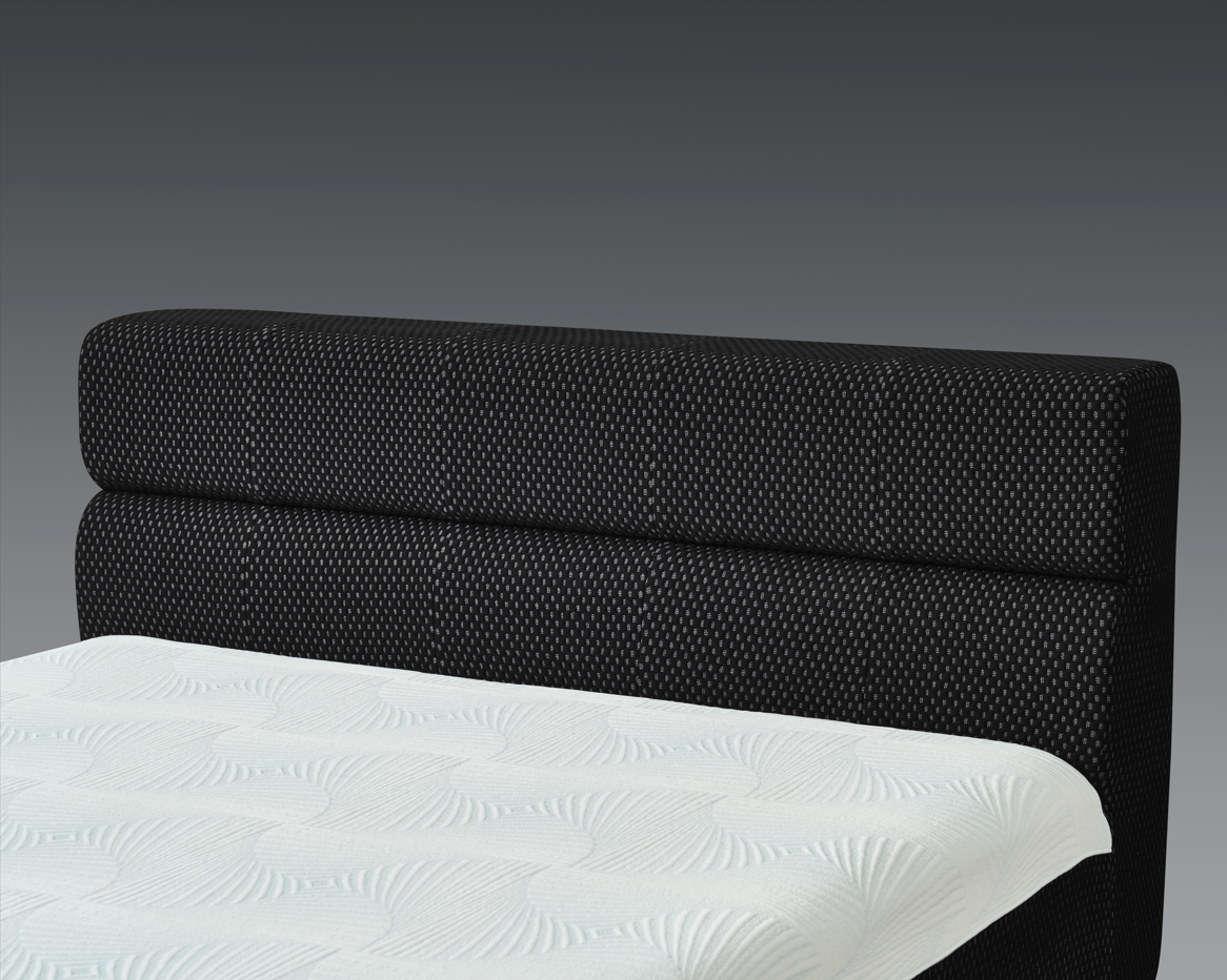 Black upholstered headboard with white mattress on a gray background