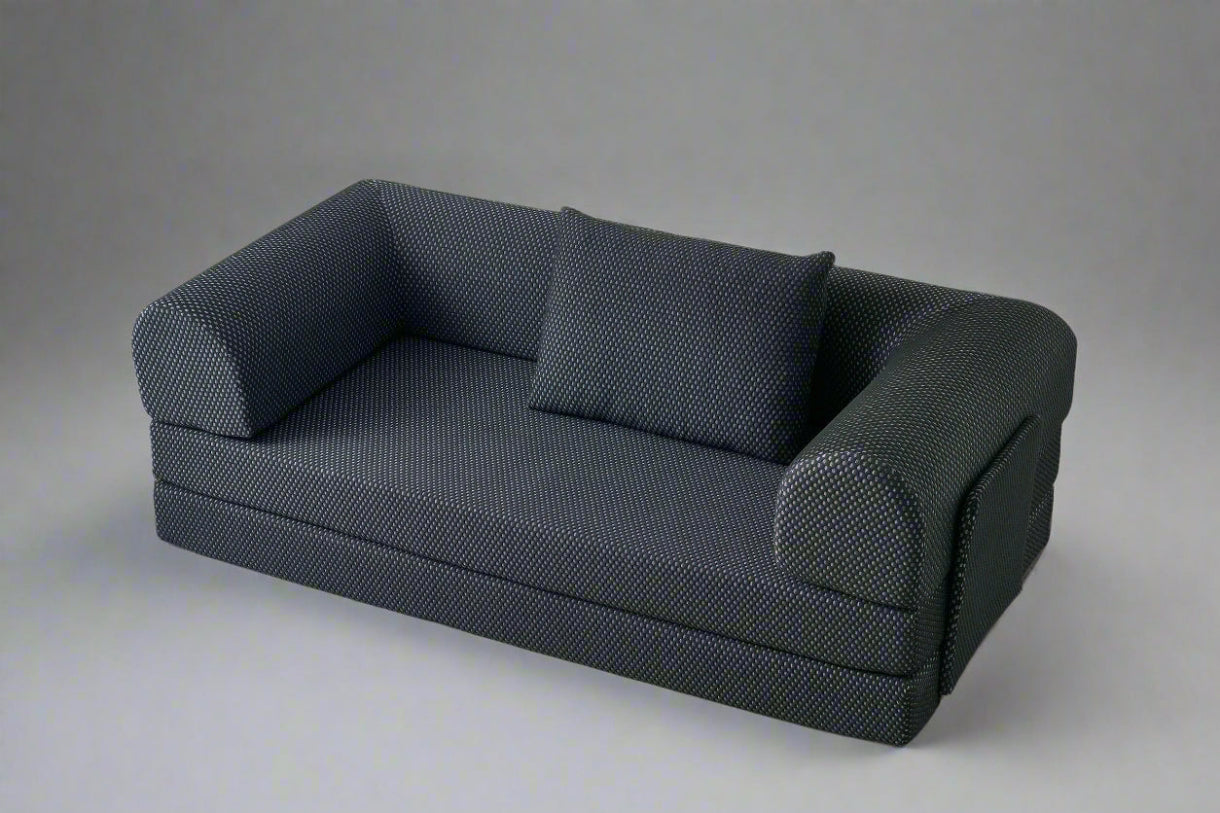 Black textured three sit sleeping sofa on a light gray background