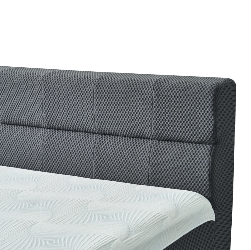 Gray upholstered headboard with white bedding on a white background