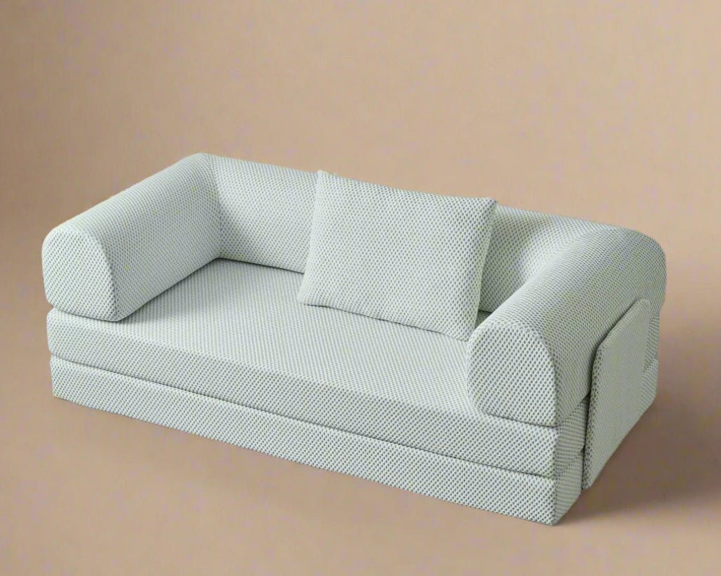 Light green sofa with a pillow on a gray background