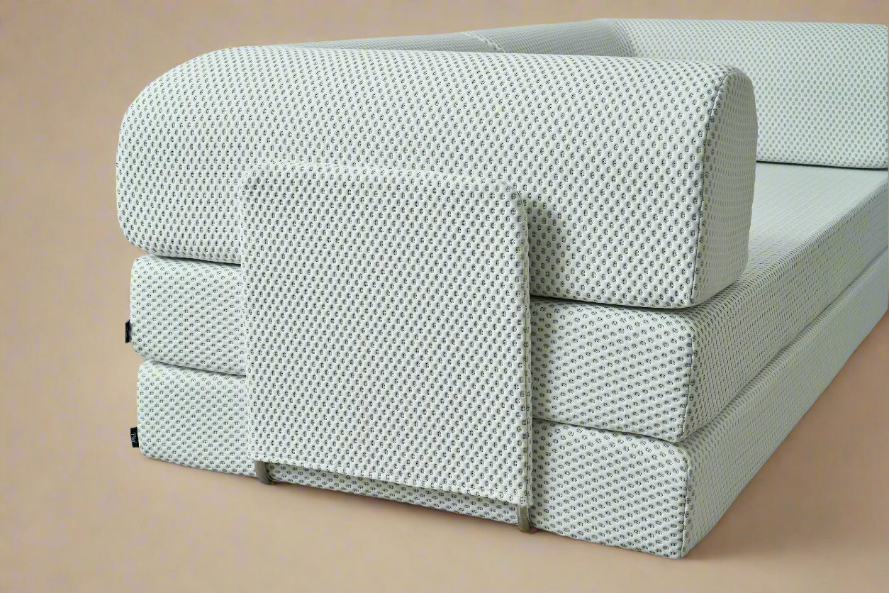 Side view White three sit sleeping sofa on a light orang  background